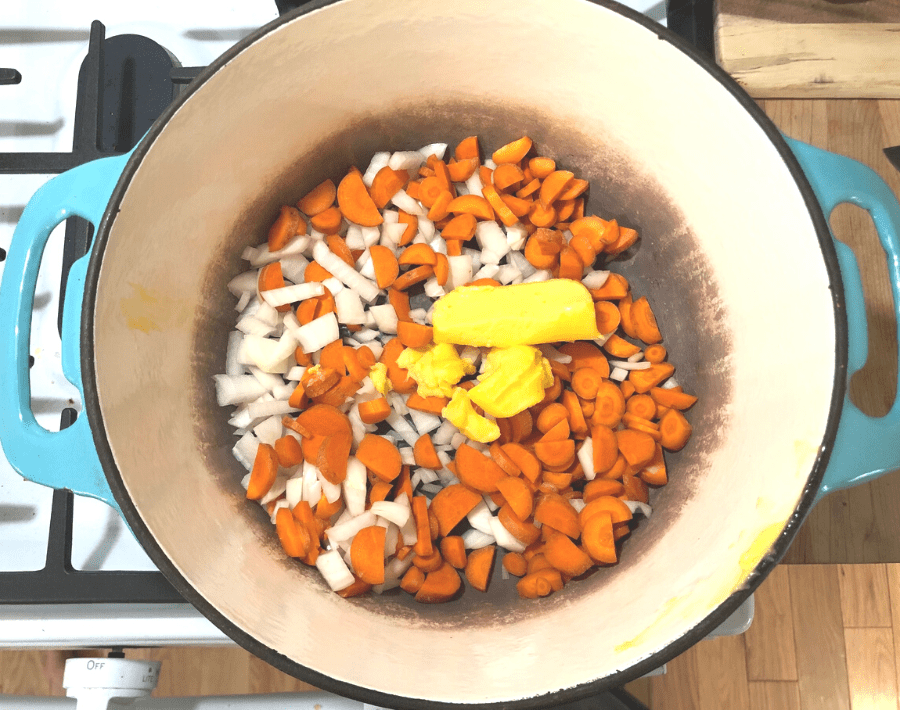 Diced carrots and onions in a dutch oven with four tablespoons of butter.
