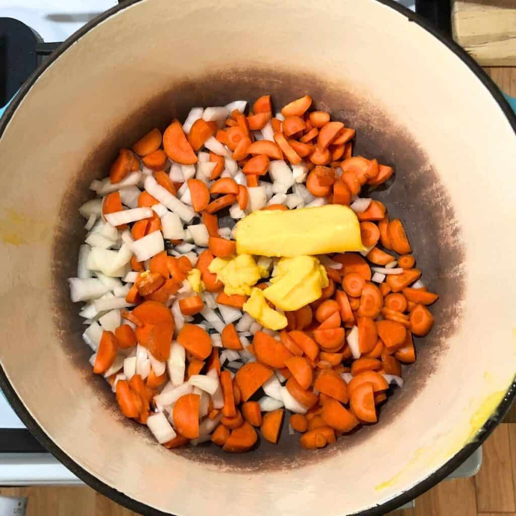 Diced carrots and onions in a Dutch oven with four tablespoons of butter.