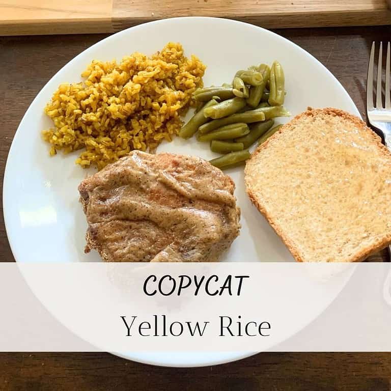 Yellow rice, green beans, homemade bread with apple jelly, and roast chicken on a white plate with a silver fork on the side. The title is "COPYCAT Yellow Rice."