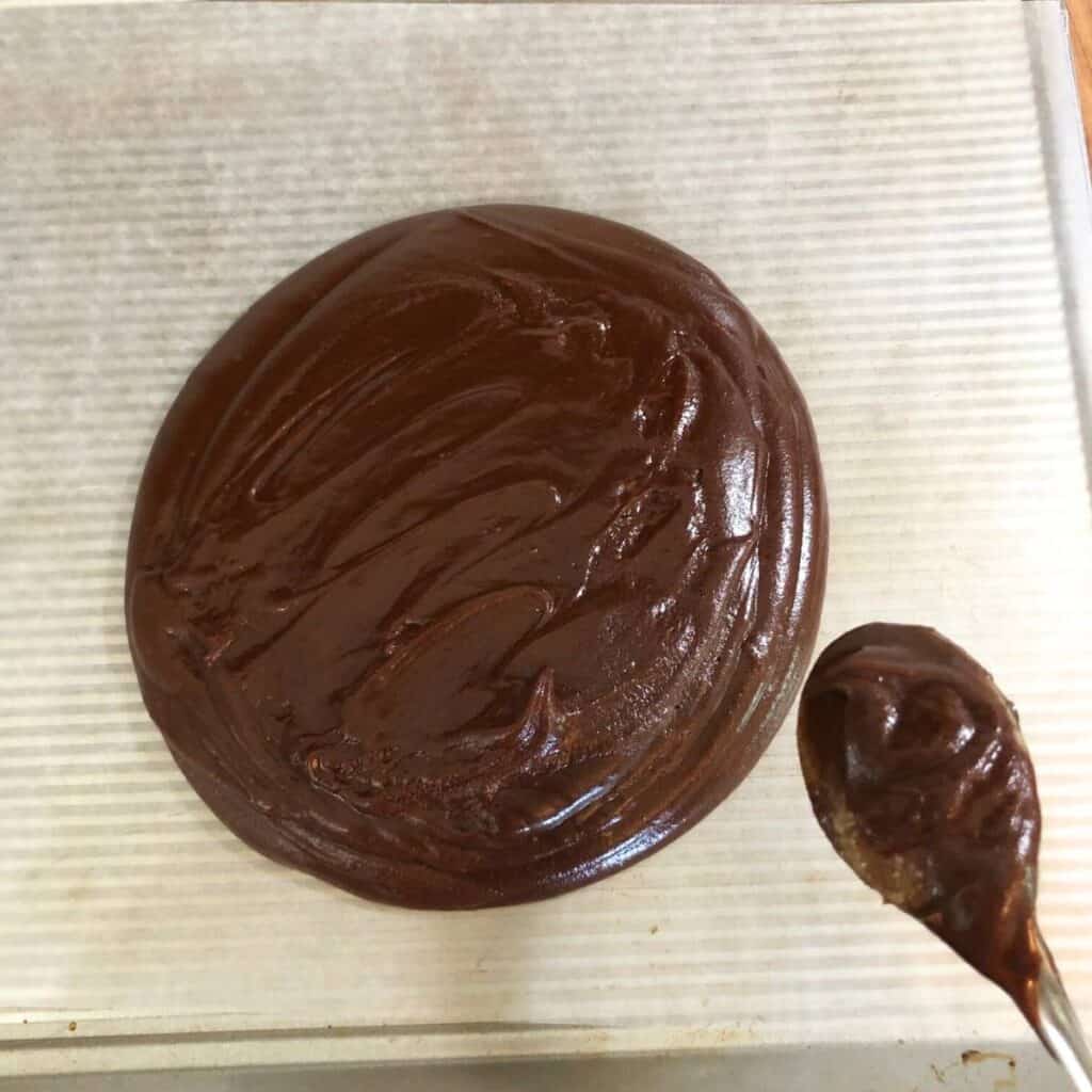 Chocolate fudge poured out onto cookie sheet lined with wax paper.