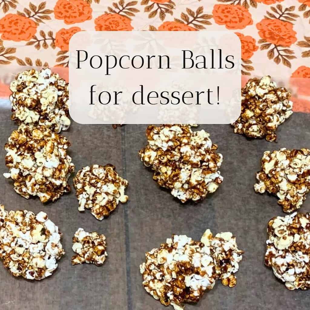 Popcorn balls on wax paper on a kitchen table with an orange and white table runner. The title is "Popcorn Balls for dessert!"