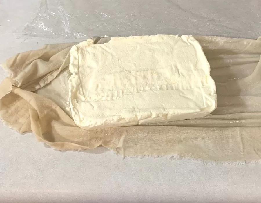 A block of homemade cream cheese.