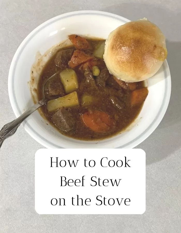 Beef stew in a white bowl with a dinner roll. The title is "How to Cook Beef Stew on the Stove."