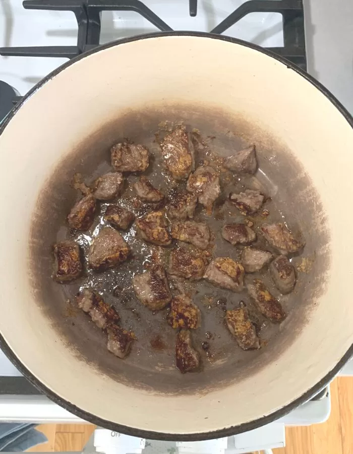 Cooked beef stew meat in a pot.