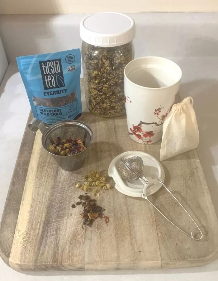 Herbal tea ingredients on a wood cutting board.