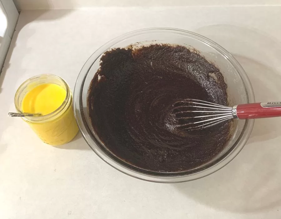 Woman mixing ingredients to make chocolate cupcakes.