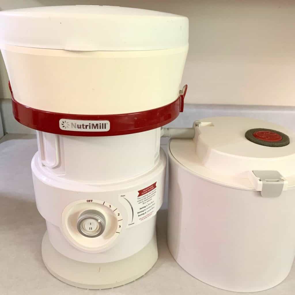 A NutriMill classic grain mill sitting on a kitchen counter.