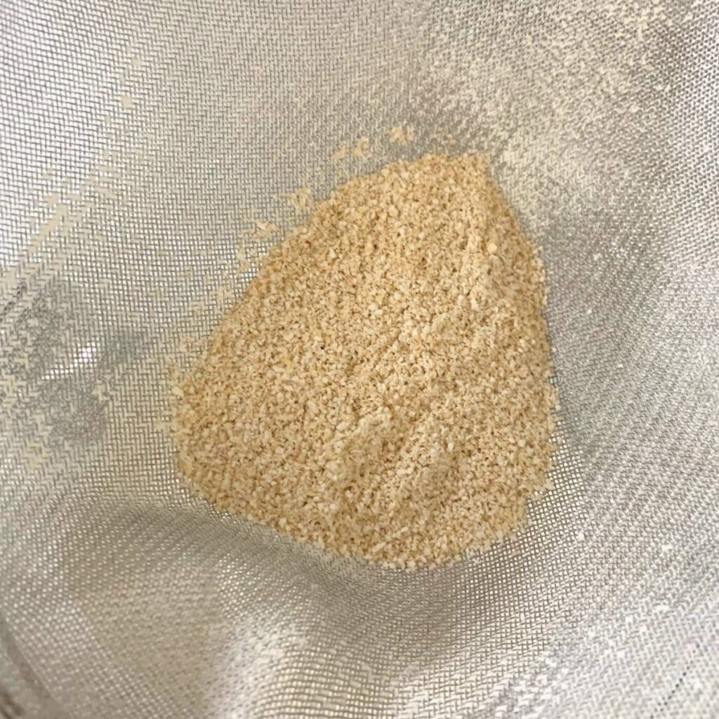 Wheat bran and wheat germ in a fine mesh sieve.