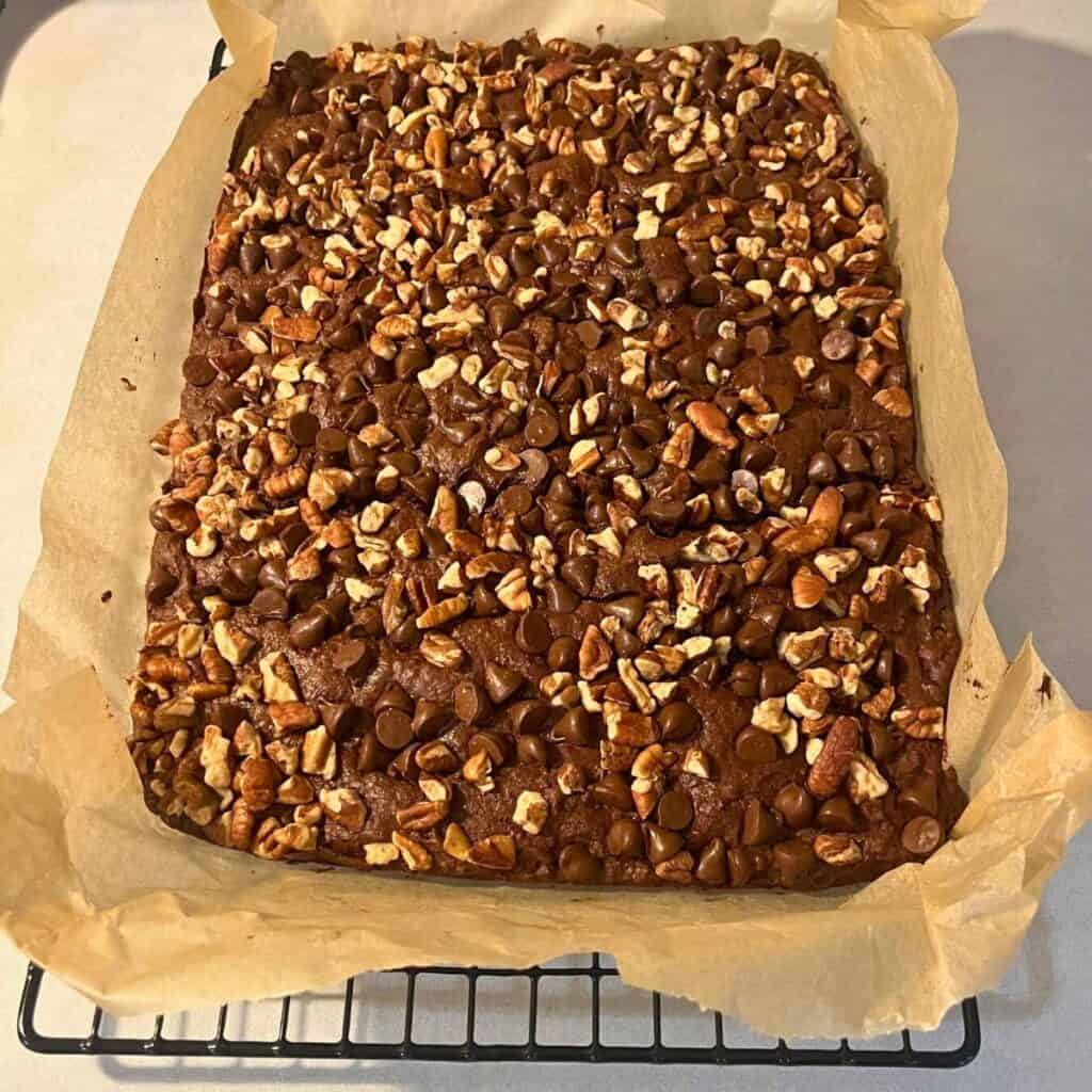 Cooked double chocolate pecan brownies cooling on a wire rack.