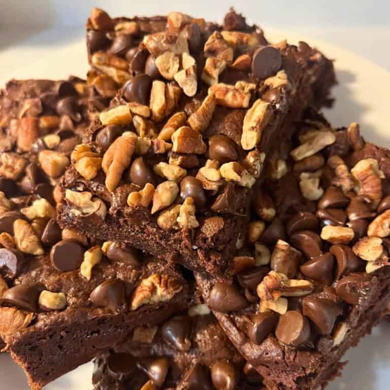 A platter of stacked double chocolate pecan brownies.