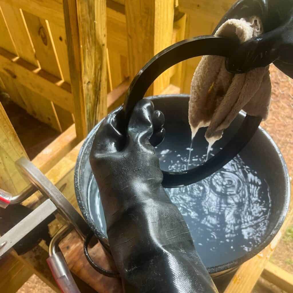 Woman washing a rubber seal with a white rag.