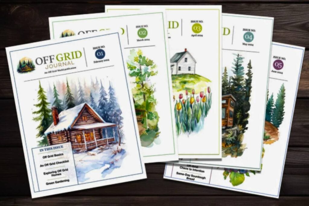 Five issues of the Off Grid Journal magazine sitting on a wood table.