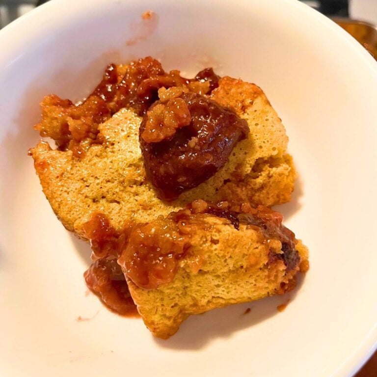 A serving of strawberry cobbler in a white bowl.