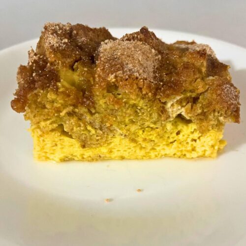 A slice of French toast casserole on a white plate.