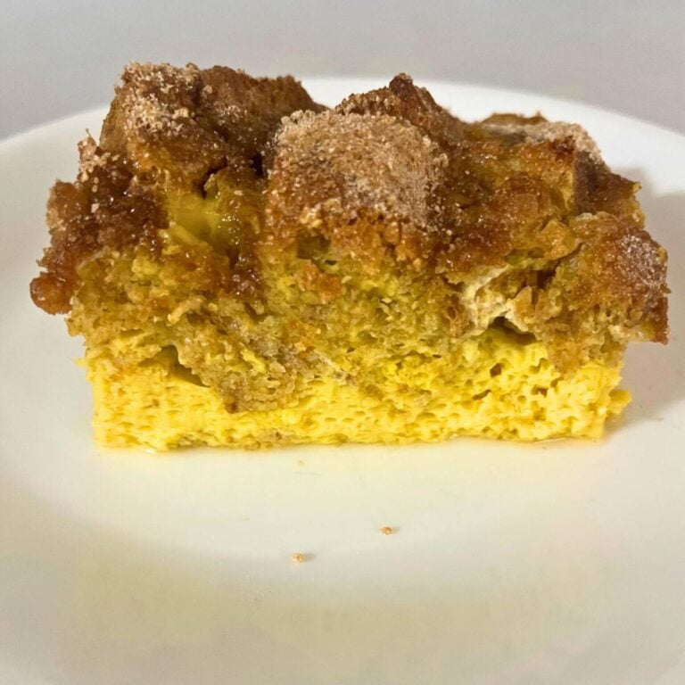 A slice of French toast casserole on a white plate.